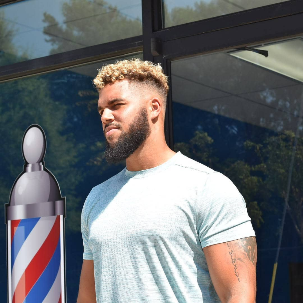 Black male outside of barbershop after haircut