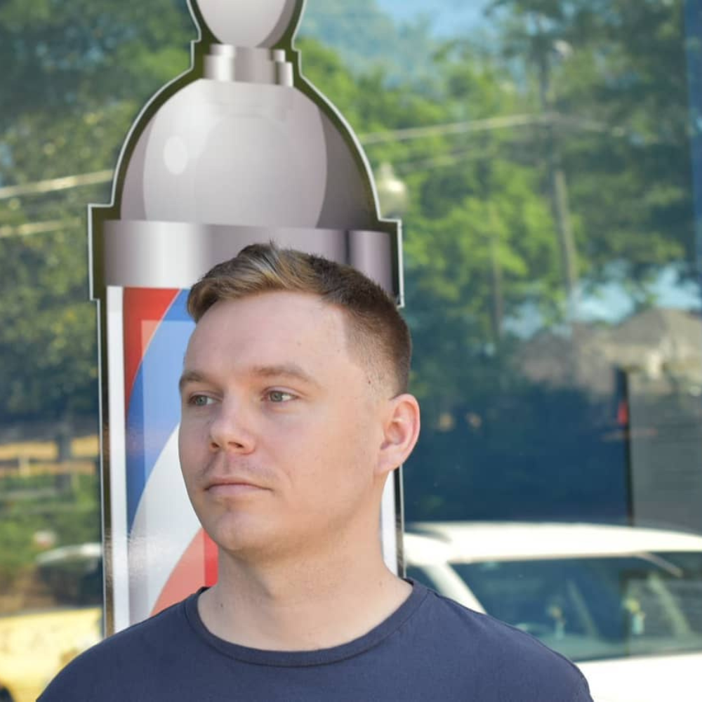 white male with lineup and fade standing outside barbershop