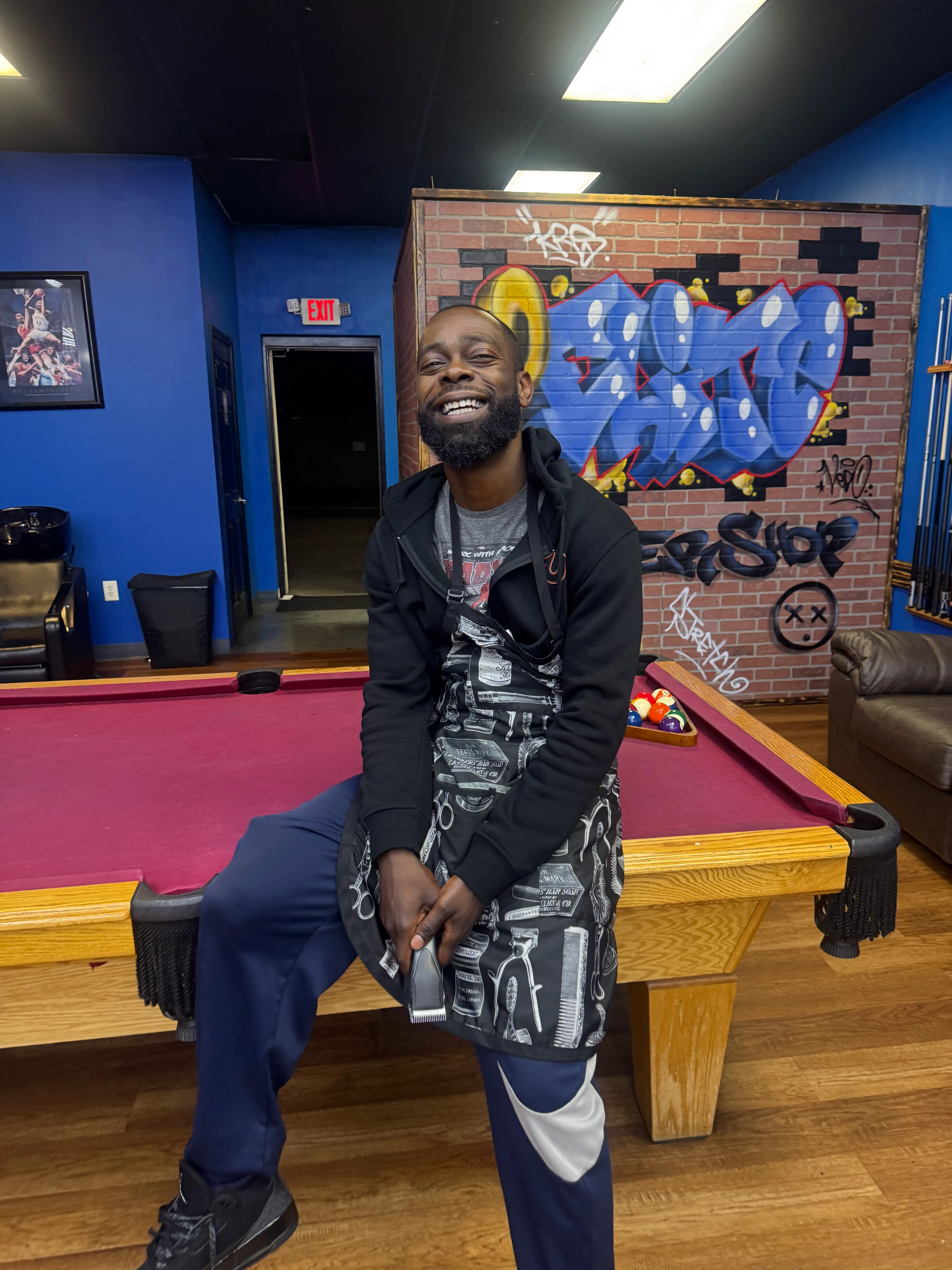 Portrait of Chris Poole, co-owner and barber at 2 Elite Barber Shop.